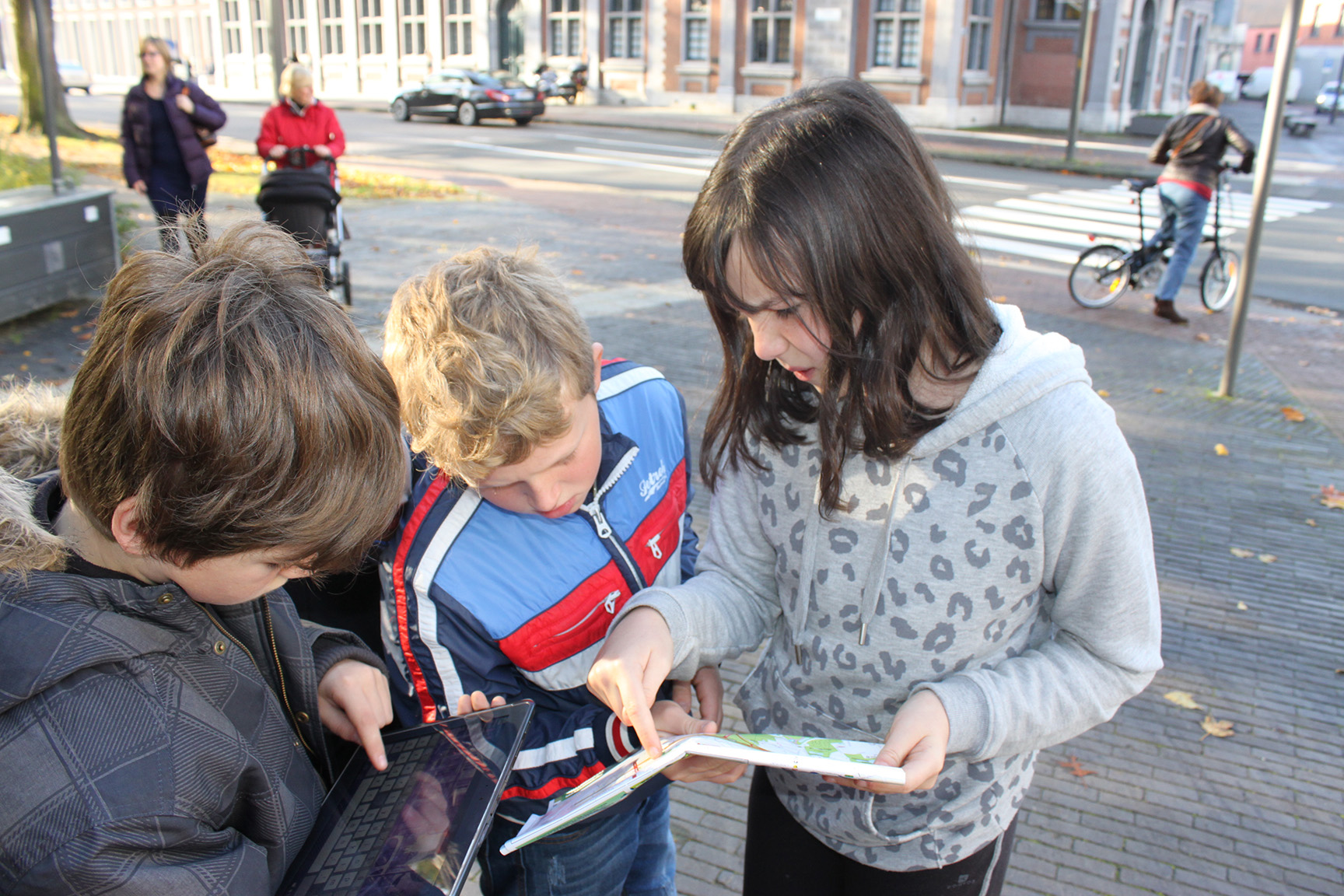 Children with a tablet on the street