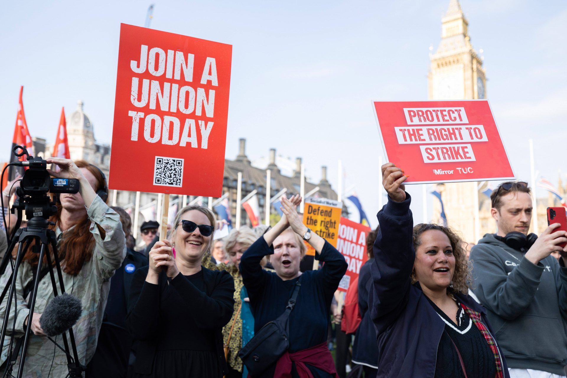 A group of protesters at Parliament Square in London holding placards with the slogans "Join a Union Today" and "Protect The Right to Strike".